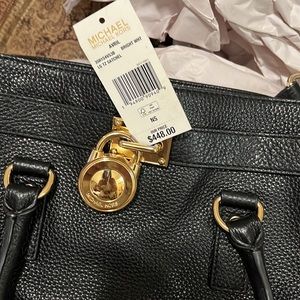 Michael Kor’s Black leather satchel purse. Brand new with tags. Gold hardware